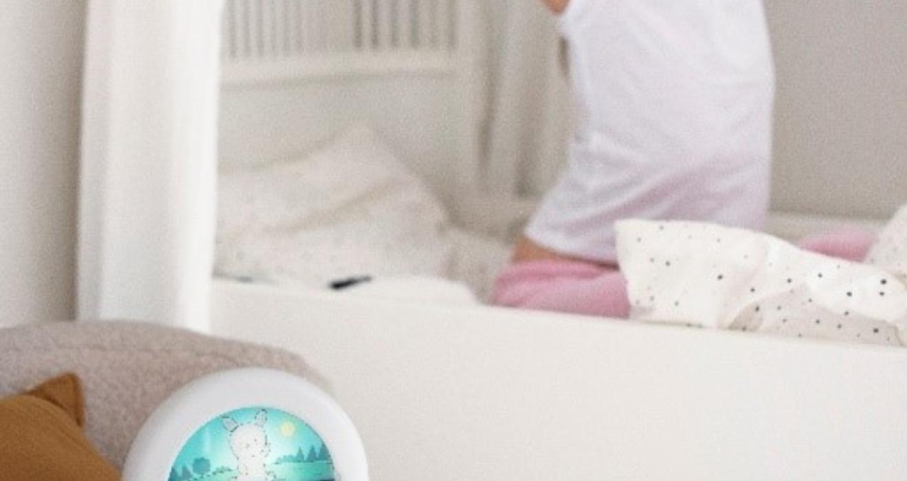 picture of a child waking up next to a Kids Essential Clock