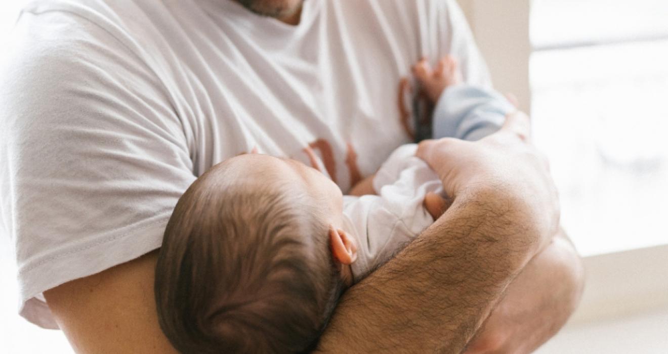 picture of a happy dad with a new baby