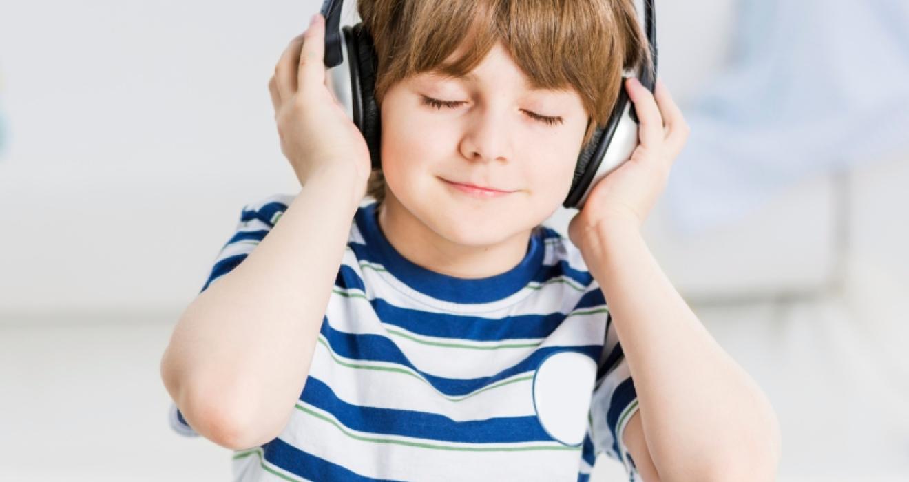 picture of a calm child wearing noise cancelling headphones