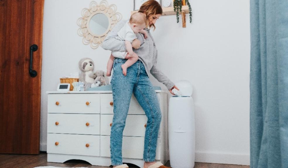 picture of a mum putting nappy in Angelcare XL nappy bin