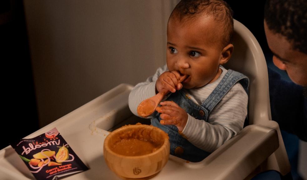 picture of a baby eating Eden’s Bloom baby food