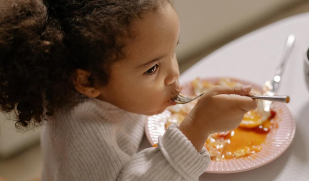 picture of a child eating in a cafe