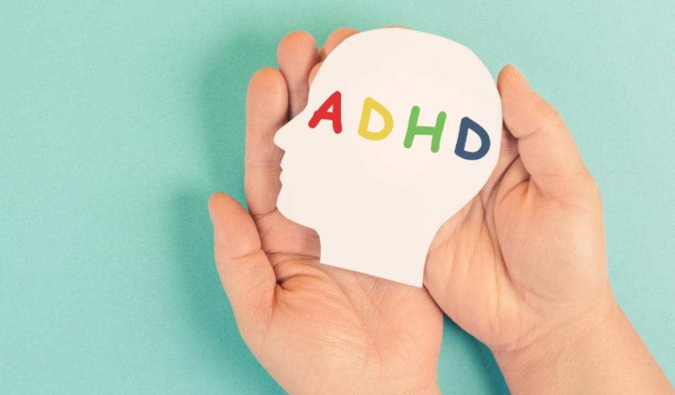 picture of a child holding picture of a head with the letters ADHD inside