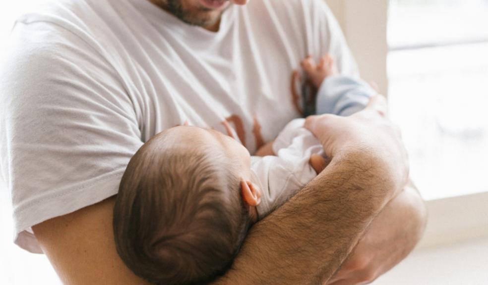 picture of a happy dad with a new baby