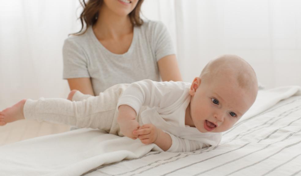 picture of a mum encouraging her baby to roll over