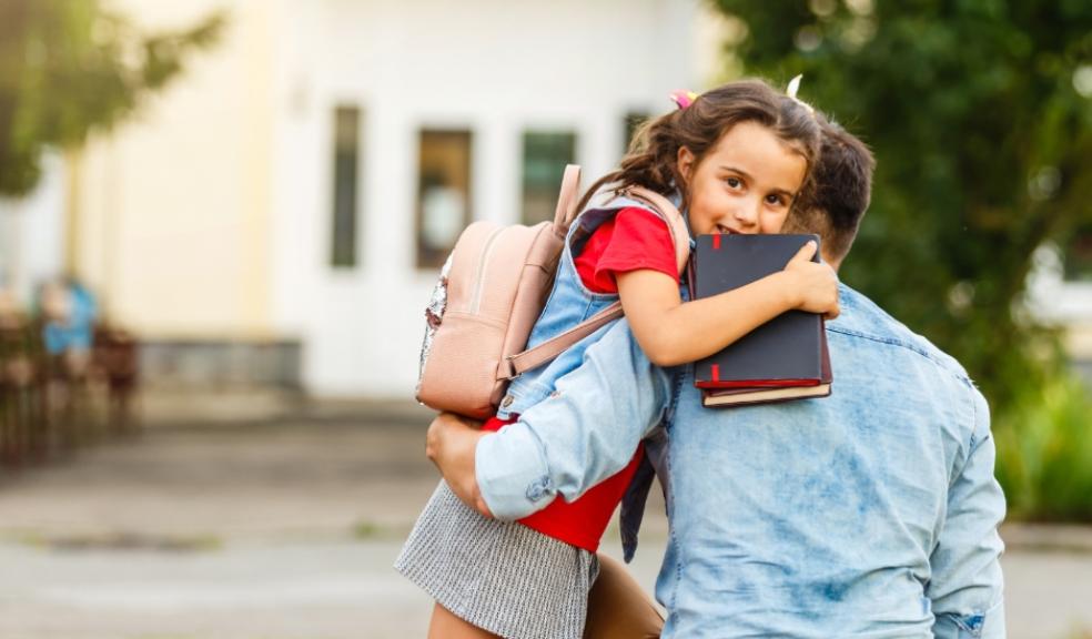 picture of a child being taken to school by parent