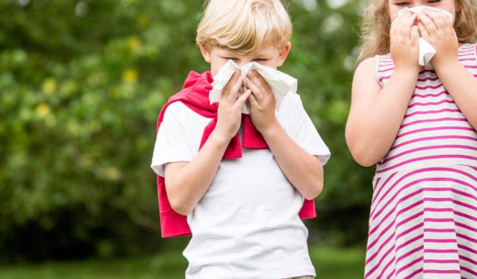 picture of children with allergies blowing their noses