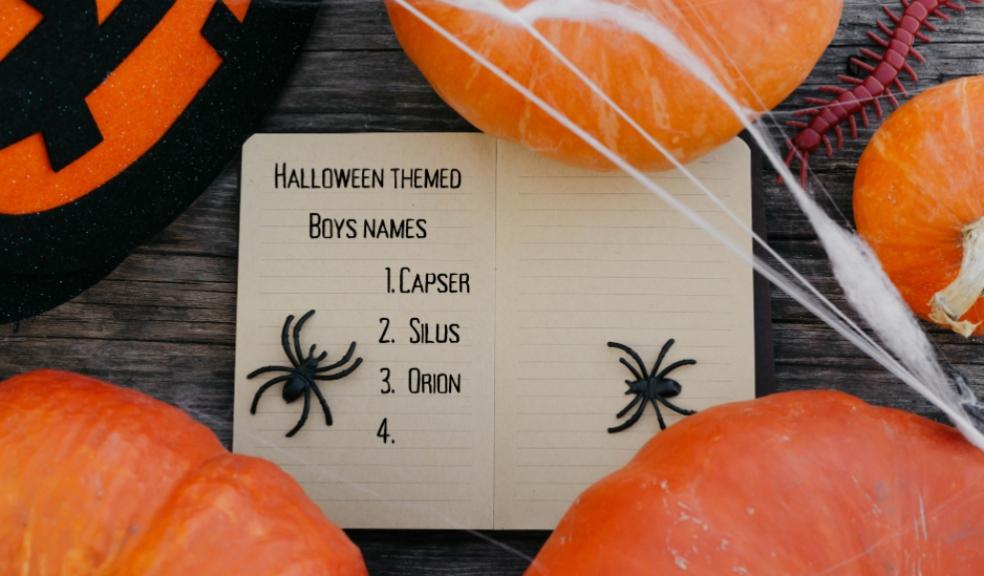 picture of Halloween themed Boys names written on Halloween note paper surrounded by pumpkins