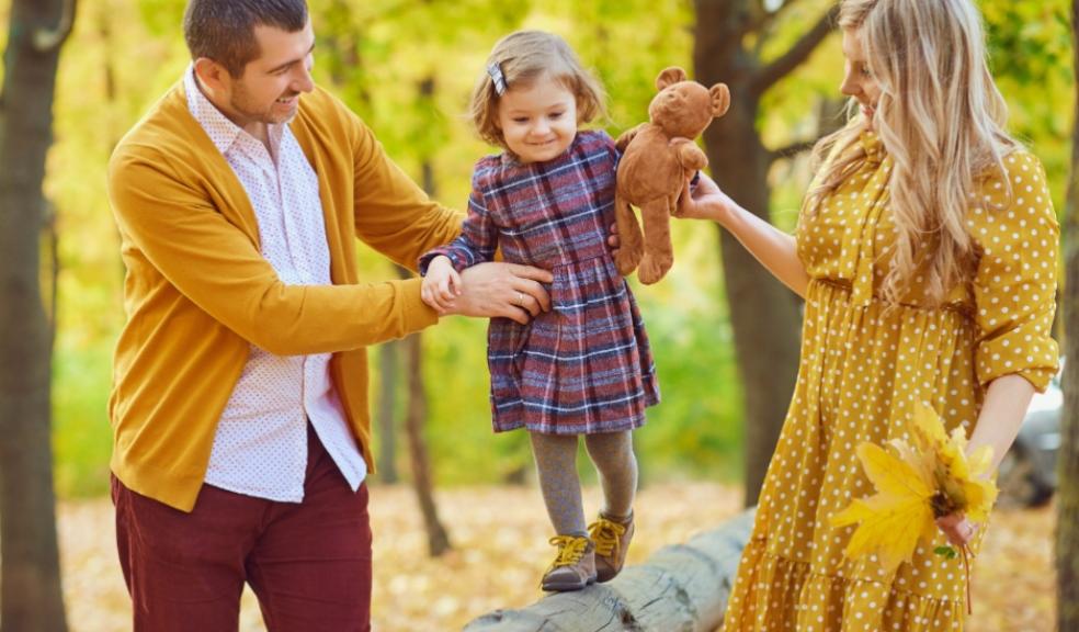 picture of a mum and dad coparenting their child in the woods