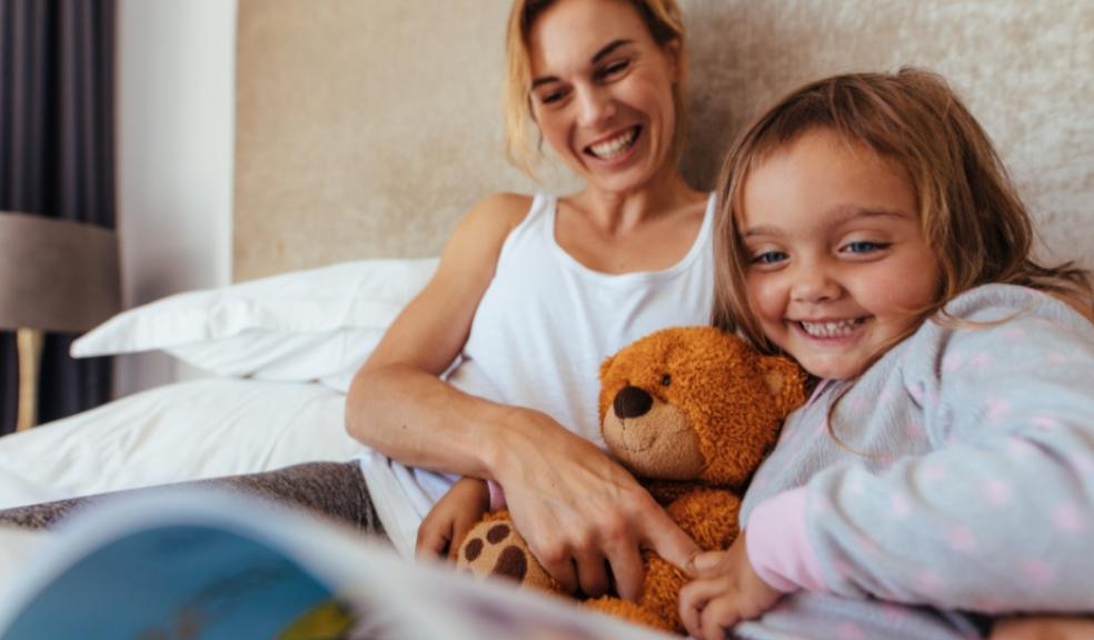 Picture of a mother and daughter in bed ready for bed time