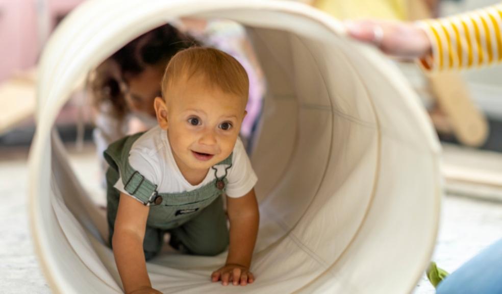 picture of a baby going through a play tunnel at nursery