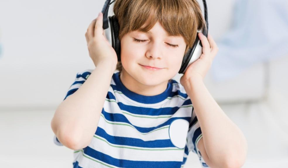 picture of a calm child wearing noise cancelling headphones