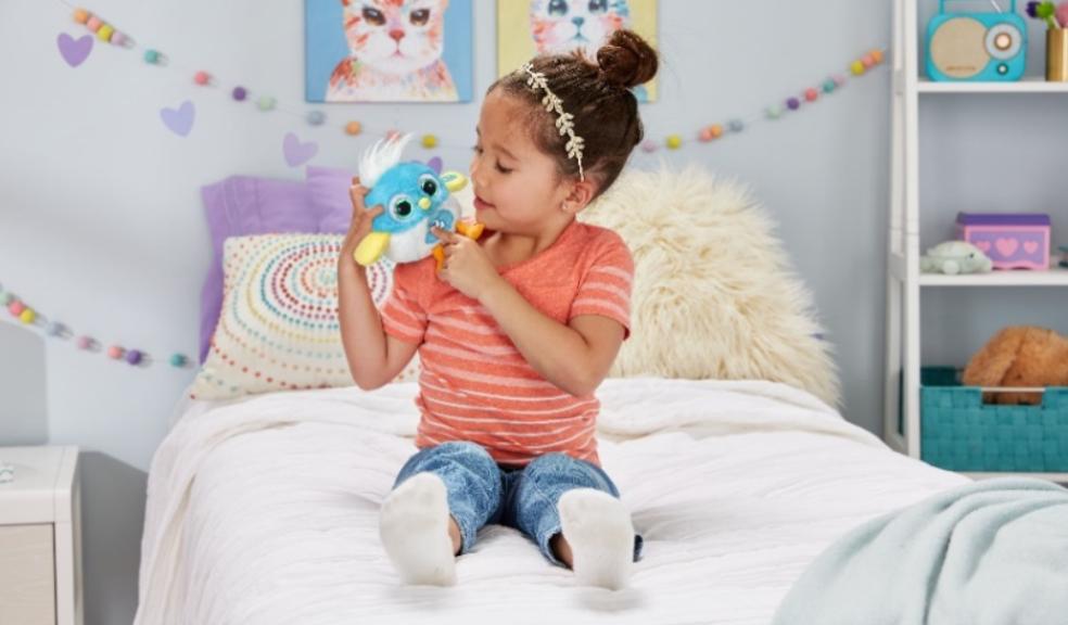 picture of a child in her bedroom playing with a LoLibird vtech toy