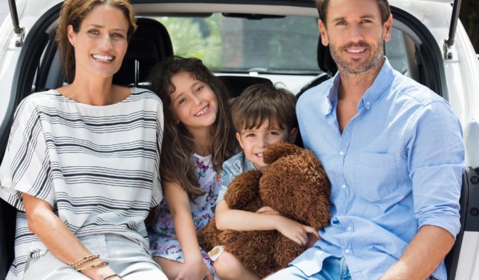 picture of family sitting in the boot of their car