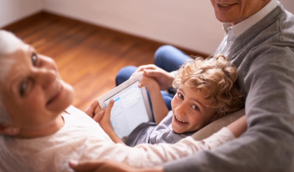 picture of grandparents using tech with a grandchild