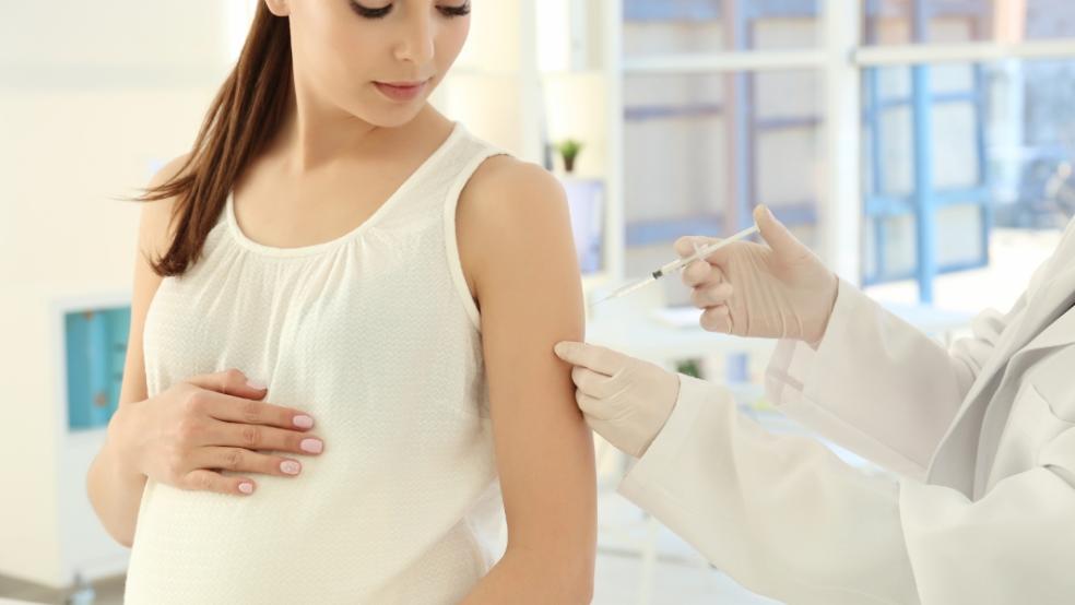 picture of pregnant woman getting a vaccination