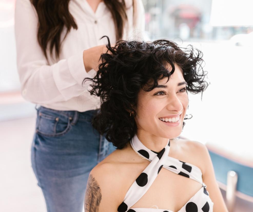 picture of a happy woman getting her hair cut