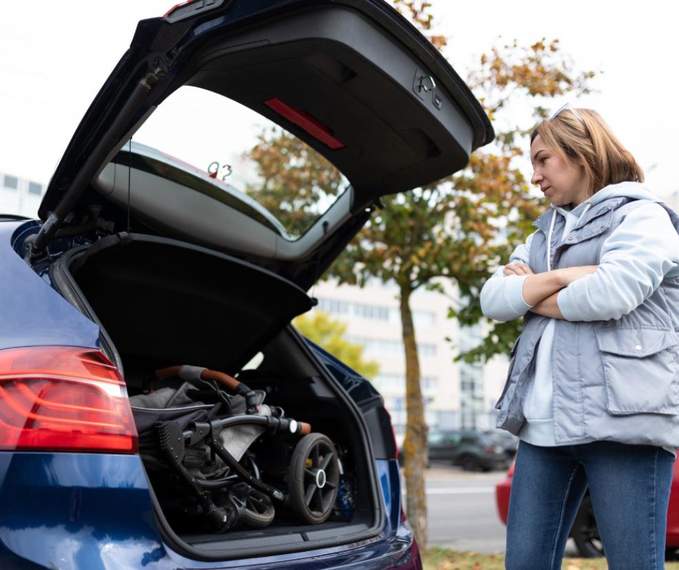 picture of mum putting a pram in the boot of her car