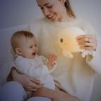 picture of a mum and baby with Angelcare Beluga Whale bedtime night light and plush toy