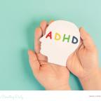 picture of a child holding picture of a head with the letters ADHD inside