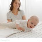 picture of a mum encouraging her baby to roll over