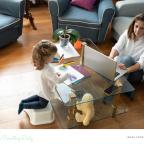 picture of a mum working from home with a child colouring