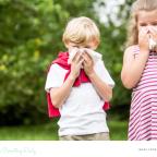 picture of children with allergies blowing their noses