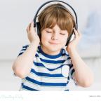 picture of a calm child wearing noise cancelling headphones