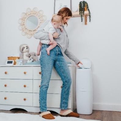 picture of a mum putting nappy in Angelcare XL nappy bin