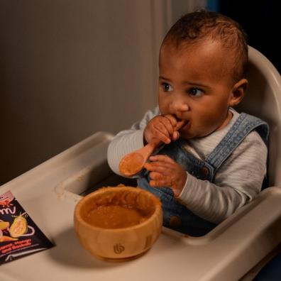 picture of a baby eating Eden’s Bloom baby food