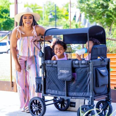 picture of a mum and her children using a WonderFold stroller wagon