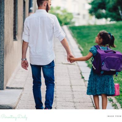 picture of a dad walking his daughter to school