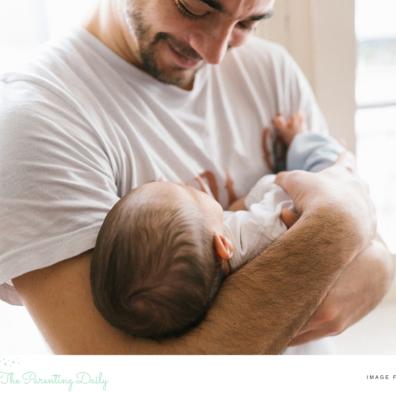 picture of a happy dad with a new baby