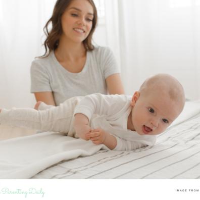 picture of a mum encouraging her baby to roll over