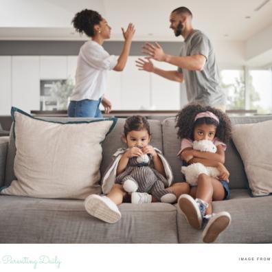 picture of children on the sofa with parents arguing behind them