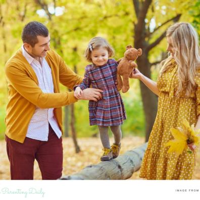 picture of a mum and dad coparenting their child in the woods