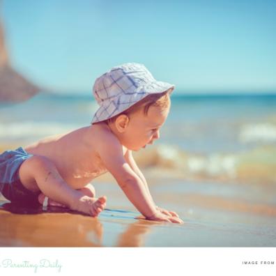 picture of a baby on a beach on a sunny day