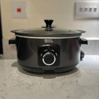 picture of a black morphy richards slow cooker on a white kitchen worktop