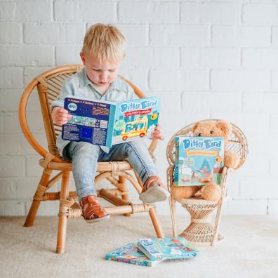 picture of a child reading Ditty Bird books