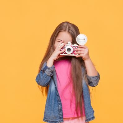 picture of a child holding a camera and taking photos