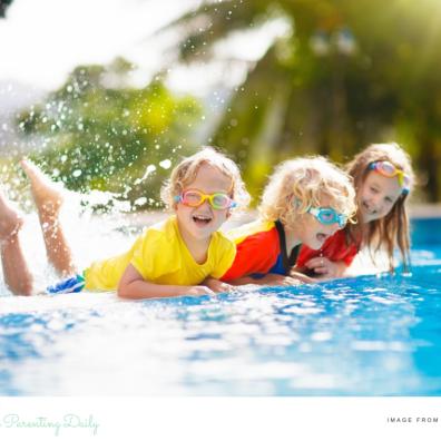 picture of happy children in brightly coloured swimwear by a pool