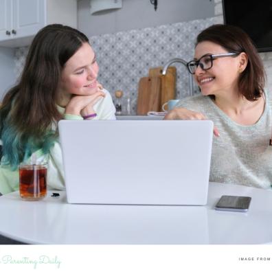 picture of a parent and teenager in the kitchen with a laptop